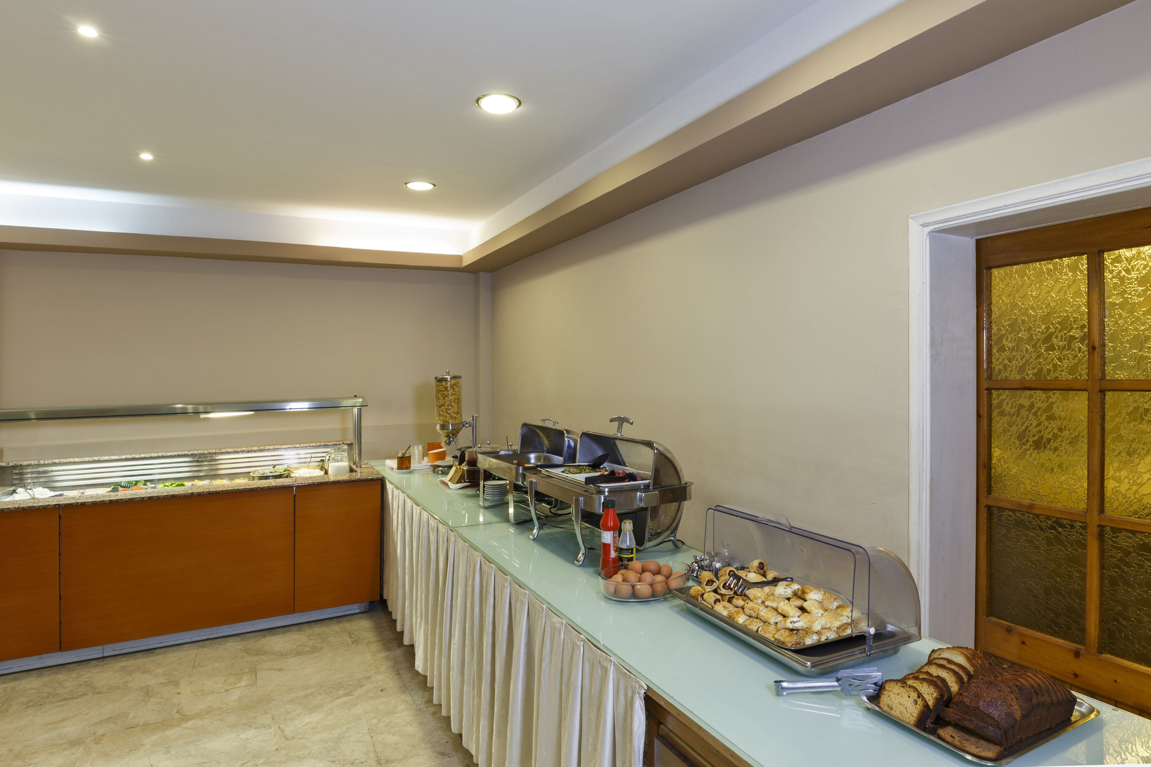 Un buffet proposant une variété de plats et une sélection de pains.