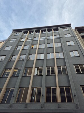 A multi-story building with a modern architectural style, featuring a grid of windows and vertical lines on the facade. - THE ALASSIA HOTEL (Athens)