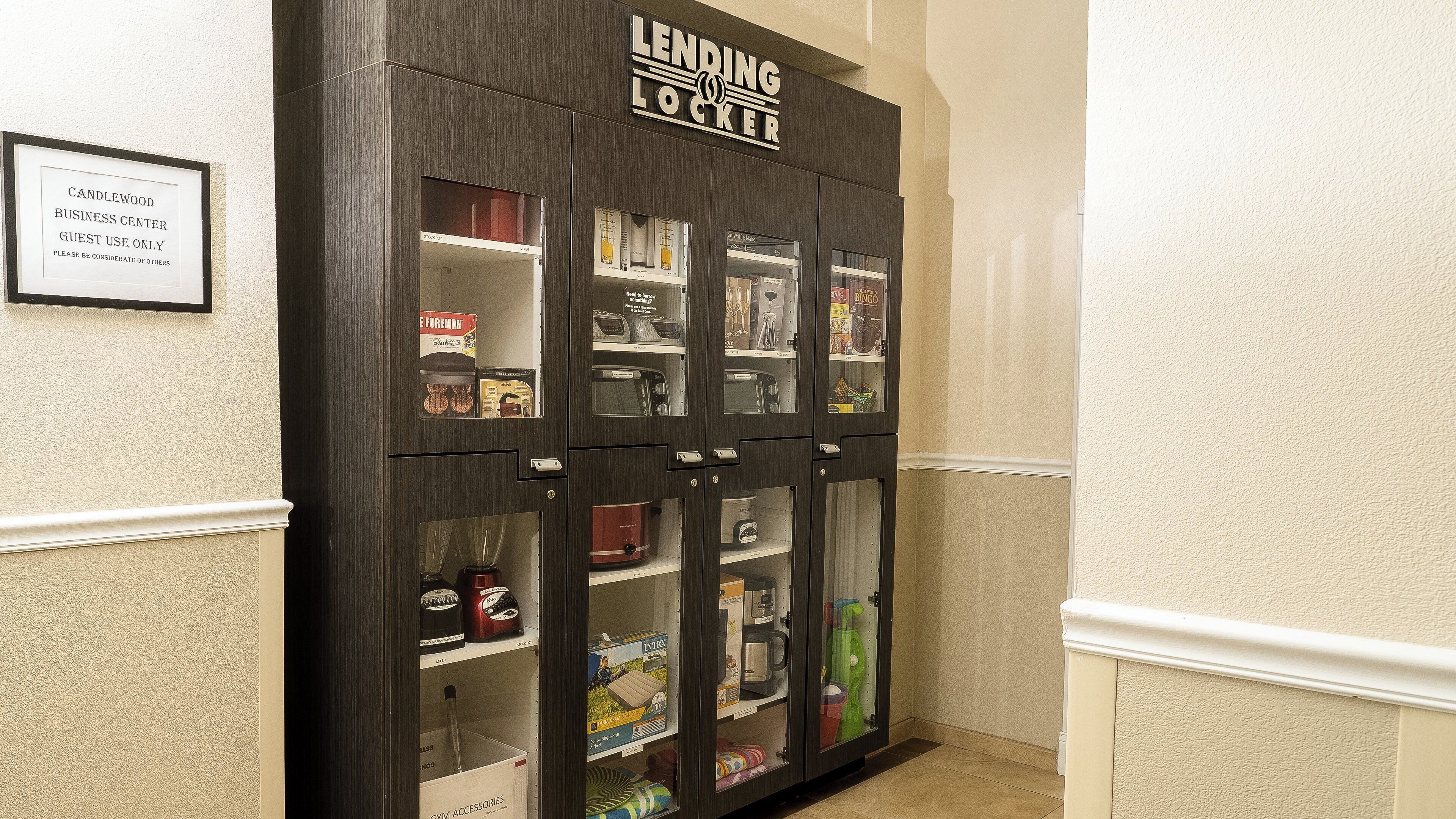 A lending locker with various items inside, including a coffee maker and a blender.