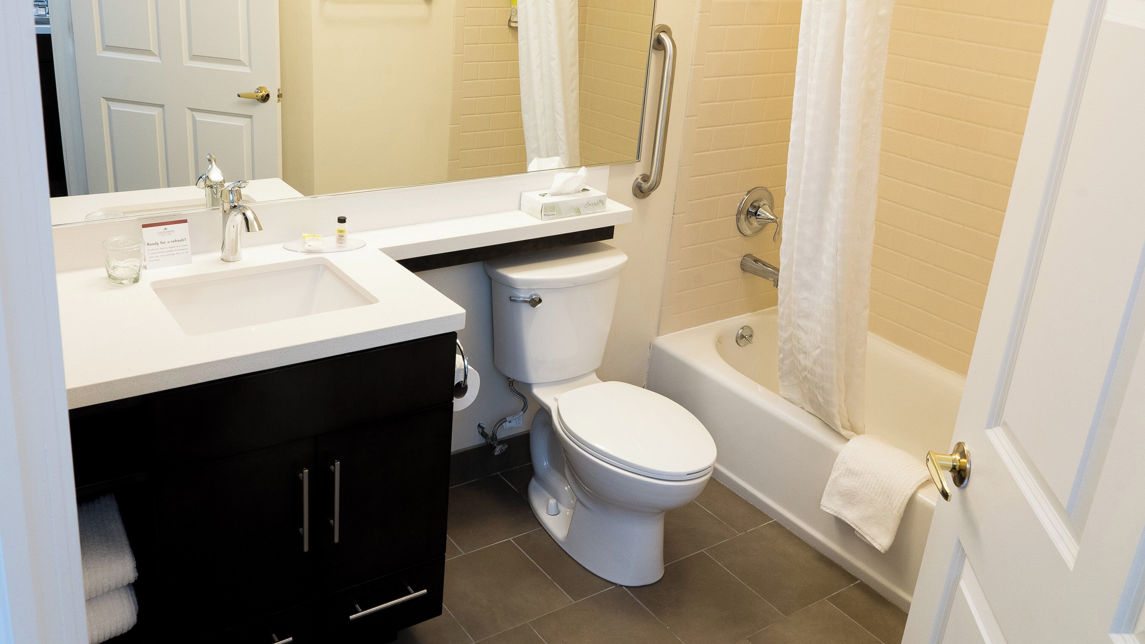 A bathroom with a white sink, a toilet, and a bathtub.