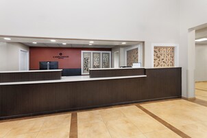 A reception desk with a sign for Candlewood Suites, a phone, and a decorative panel.