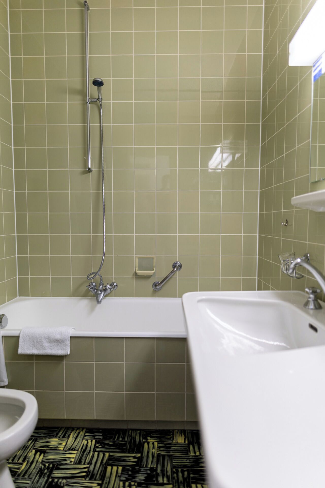 A bathroom with a bathtub, a sink, and a toilet.