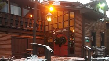 A wooden building with a sign reading "Summit Lodge".