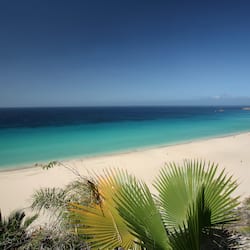 On the beach, white sand, sun loungers, beach umbrellas