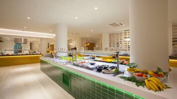 A buffet area with various food options and a green-lit counter.