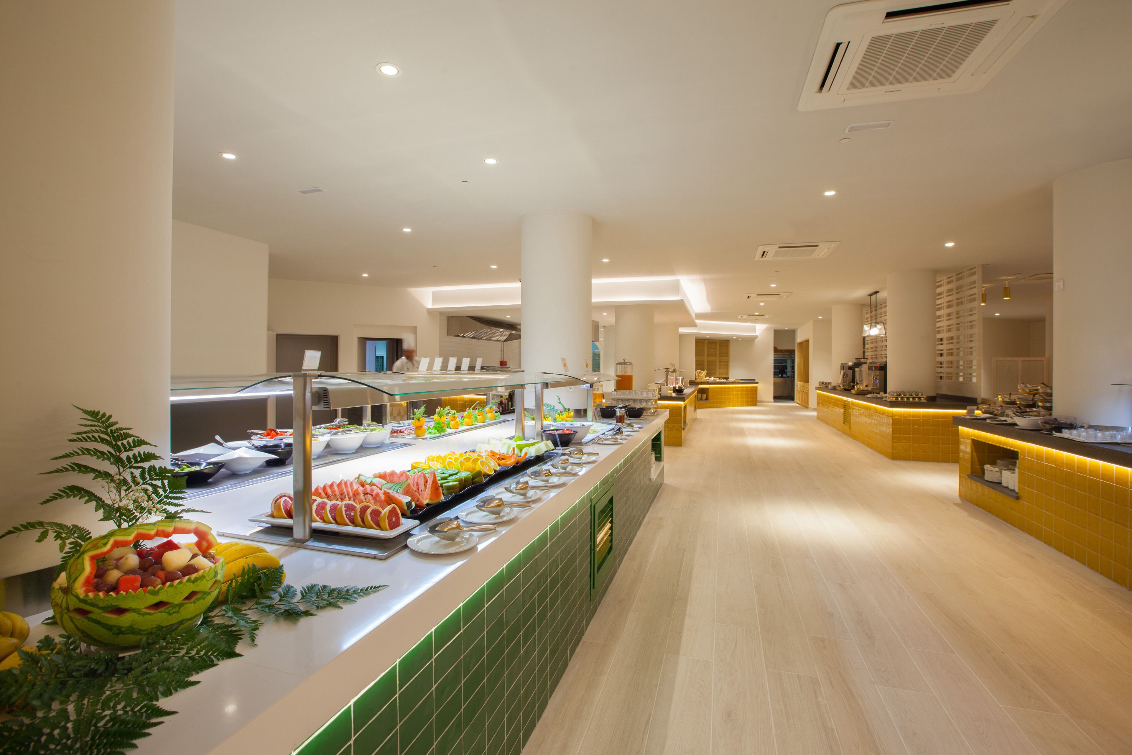 A buffet area with a variety of food items and a long counter.