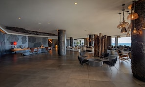 A spacious lobby with a reception desk, seating area, and large windows overlooking the sea. - Hotel Faro, a Lopesan Collection Hotel - Adults Only (San Bartolomé de Tirajana)