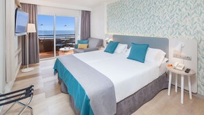A hotel room with a large bed, a desk, a chair, a TV, and a view of the ocean. - Abora Continental by Lopesan Hotels - All Inclusive (San Bartolomé de Tirajana)