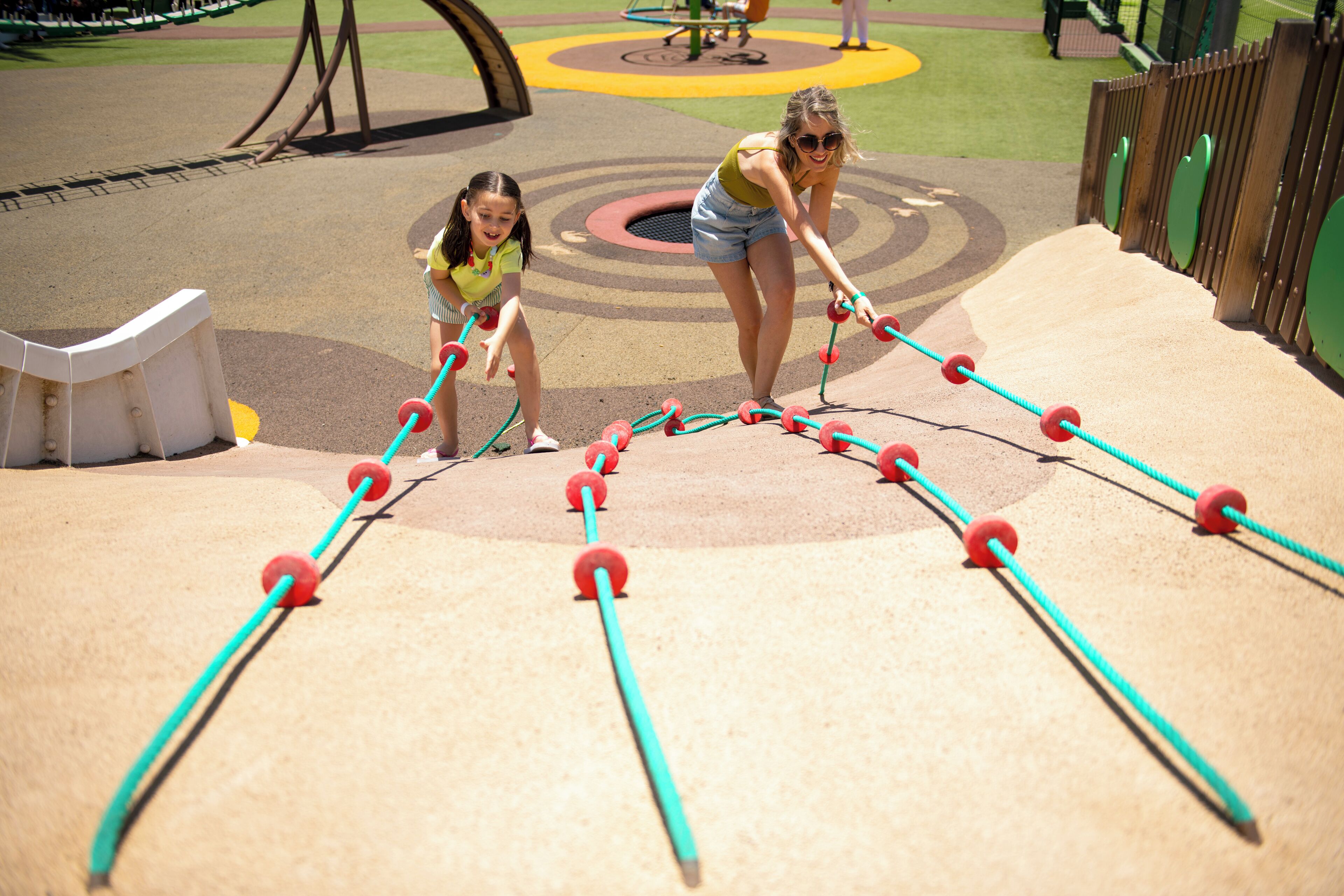 A playground with a climbing structure and a slide.