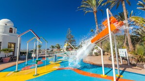 A water park with colorful play areas and a white building with a dome in the background. - Abora Interclub Atlantic by Lopesan Hotels - All inclusive (San Bartolomé de Tirajana)