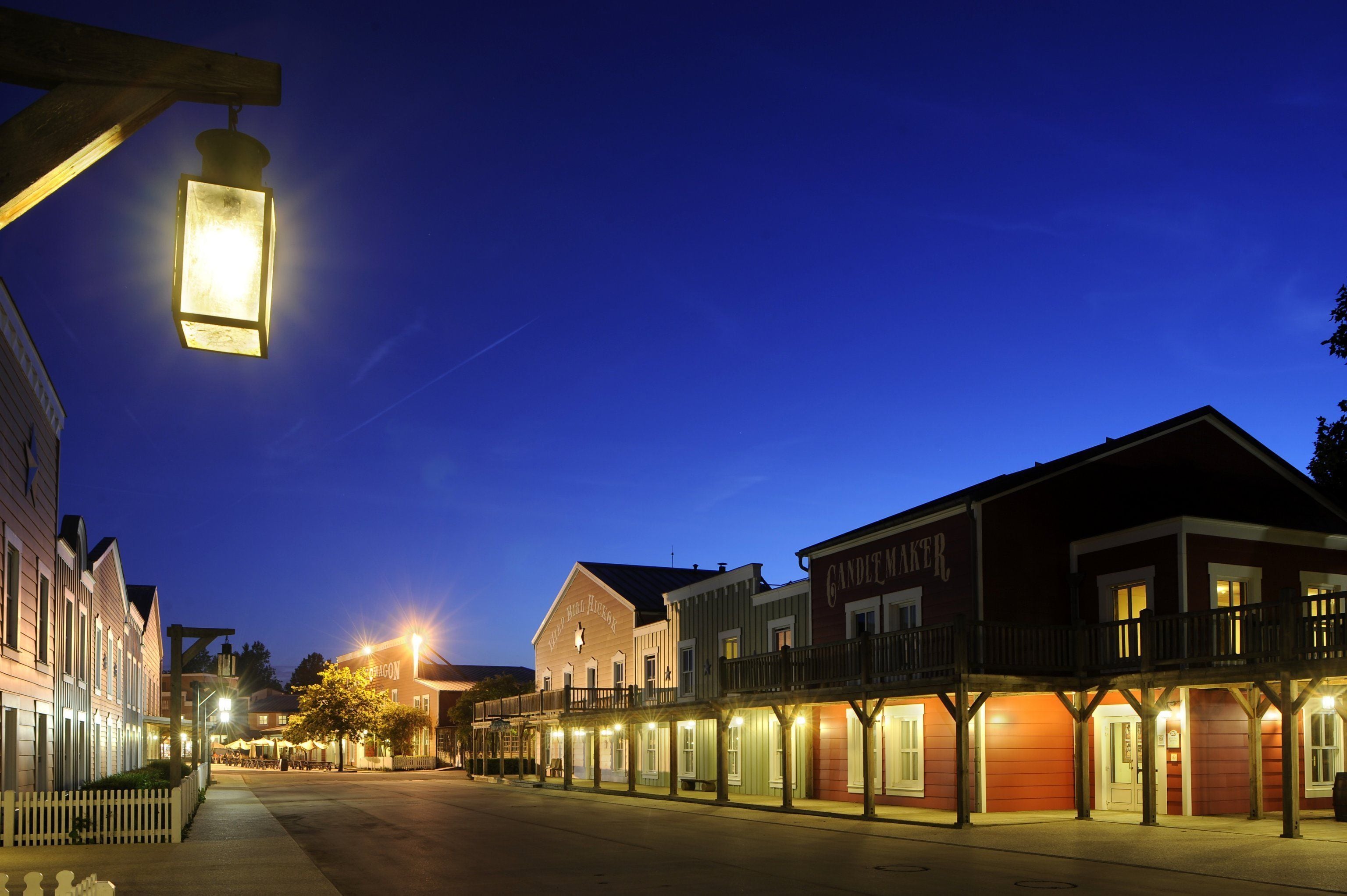 A historic street with buildings featuring balconies and storefronts.