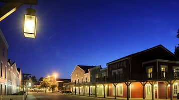 A historic street with buildings featuring balconies and storefronts.