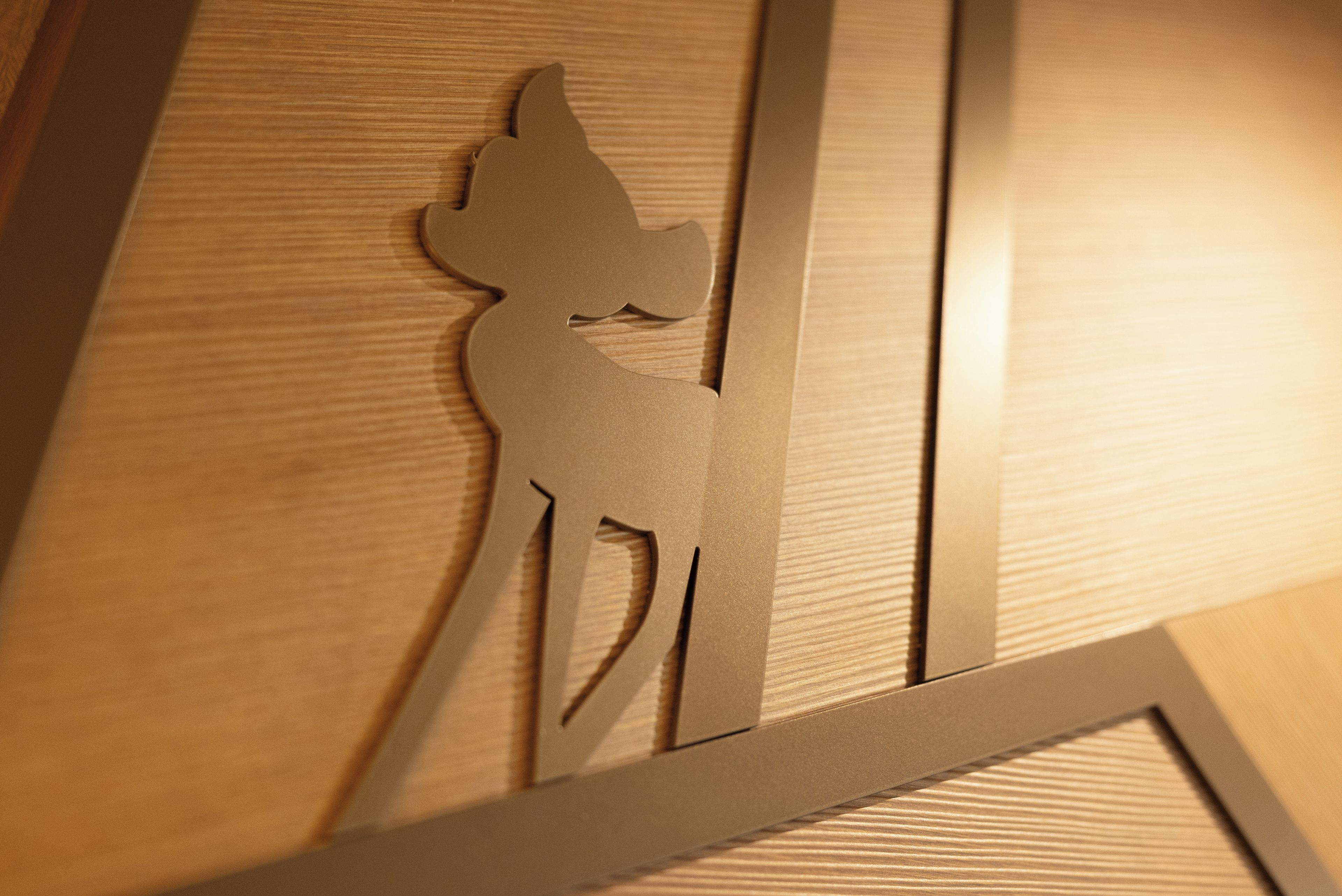 A wooden panel with a cut-out silhouette of a person.