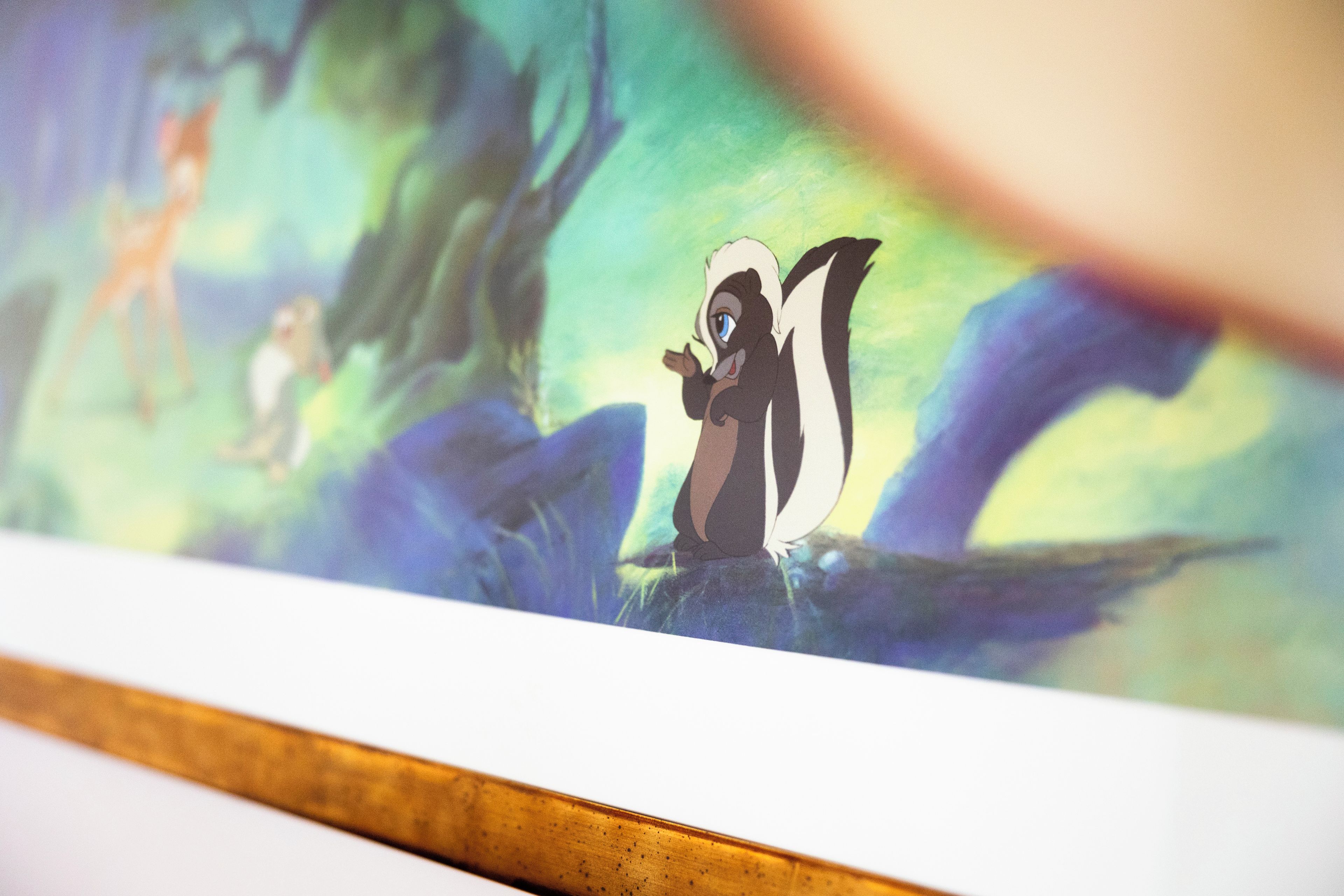 A framed artwork with a character in a forest setting.