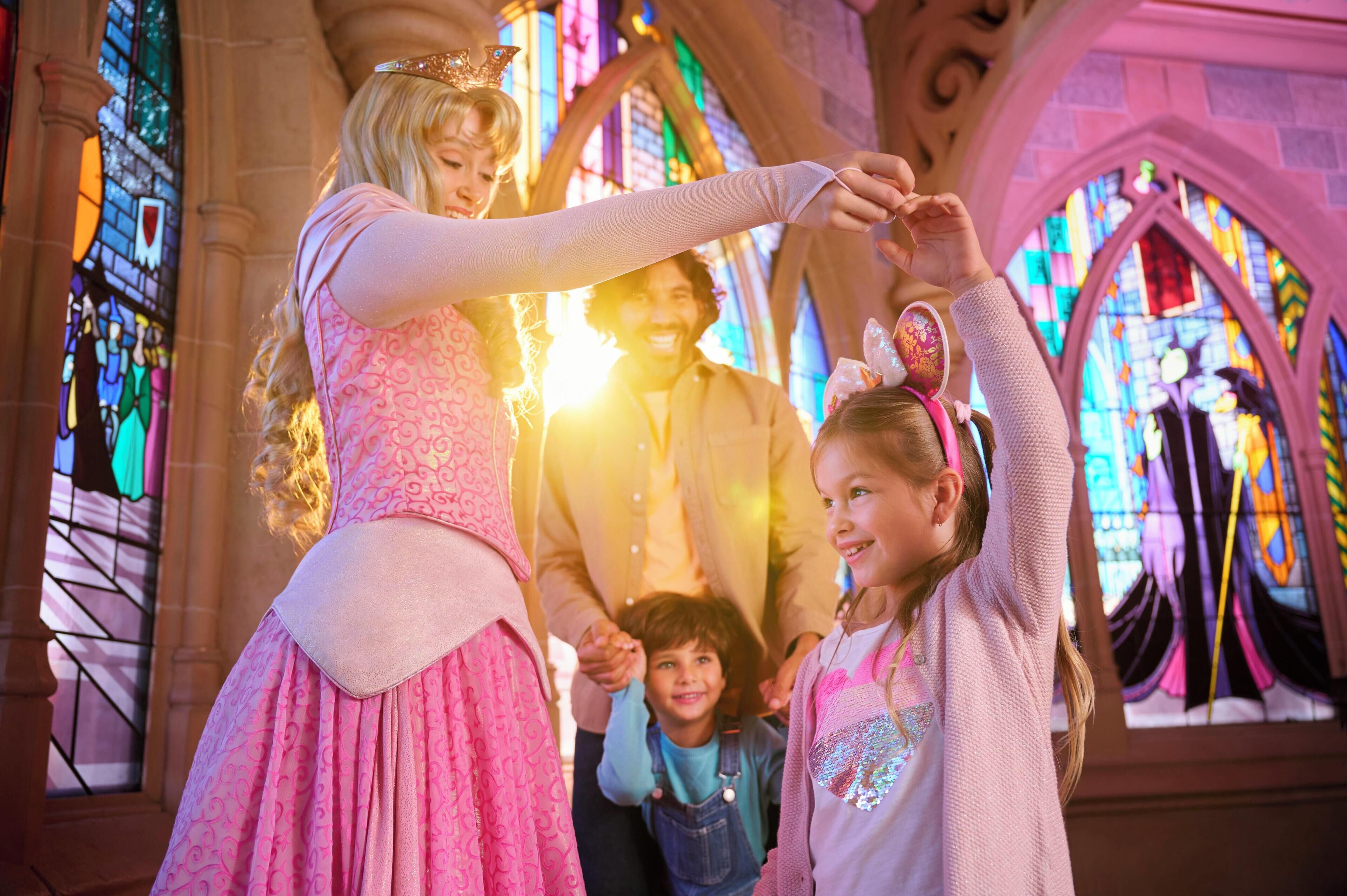 A family in a church with stained glass windows.