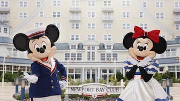 Mickey and Minnie Mouse in front of the Newport Bay Club hotel.