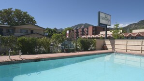 A swimming pool with a clear view of the surrounding buildings, including a sign for Boulder University Inn. - Boulder University Inn (Boulder)