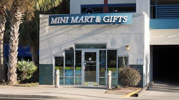 A storefront with a sign reading "MINI MART & GIFTS".
