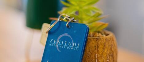 A blue tag with "ZENITUDE HOTEL RESIDENCES Le Cannet" and a website URL.