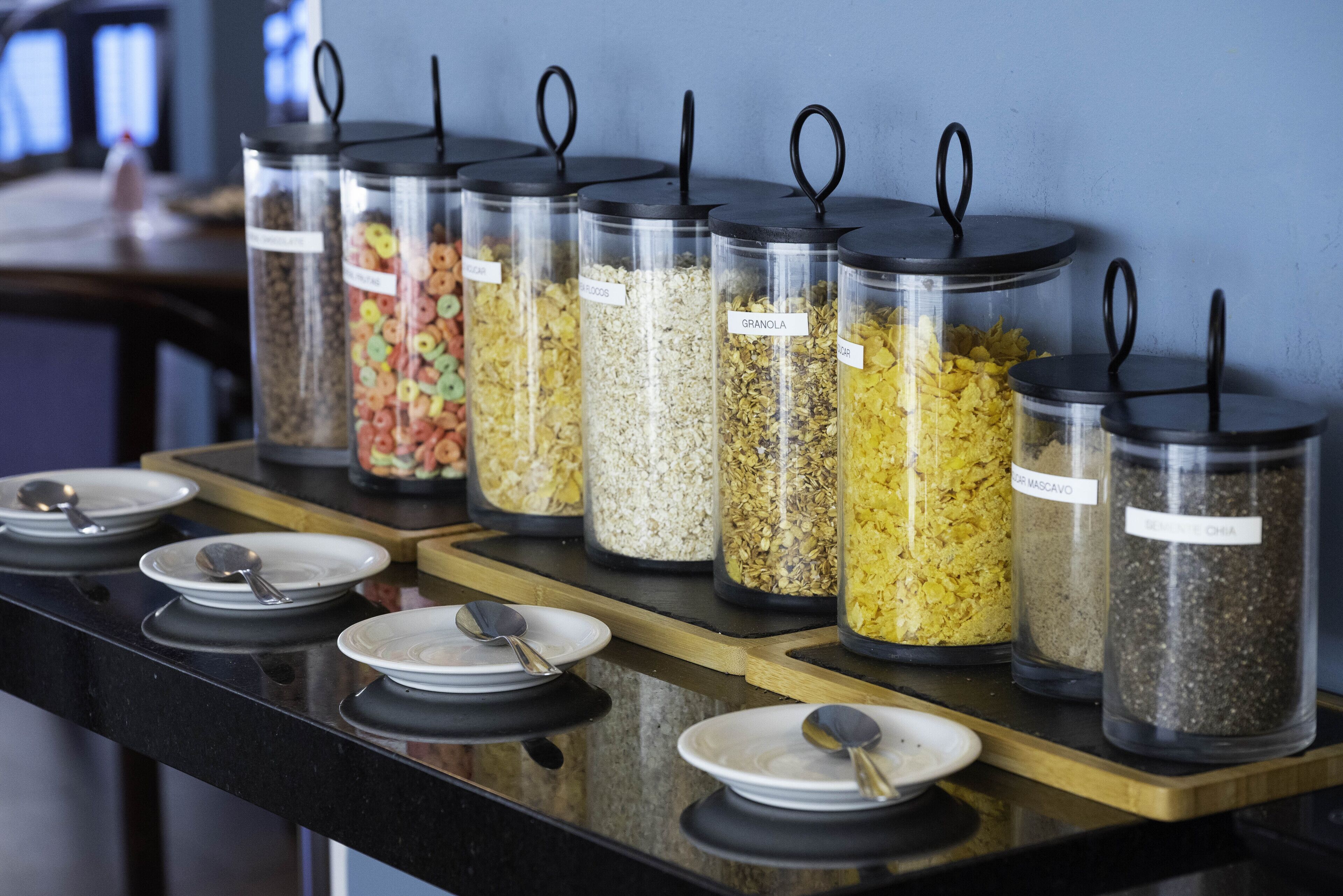 A buffet setup with various food containers labeled with different food items.