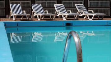 Relax by the pool with comfortable lounge chairs and a clear view of the water.