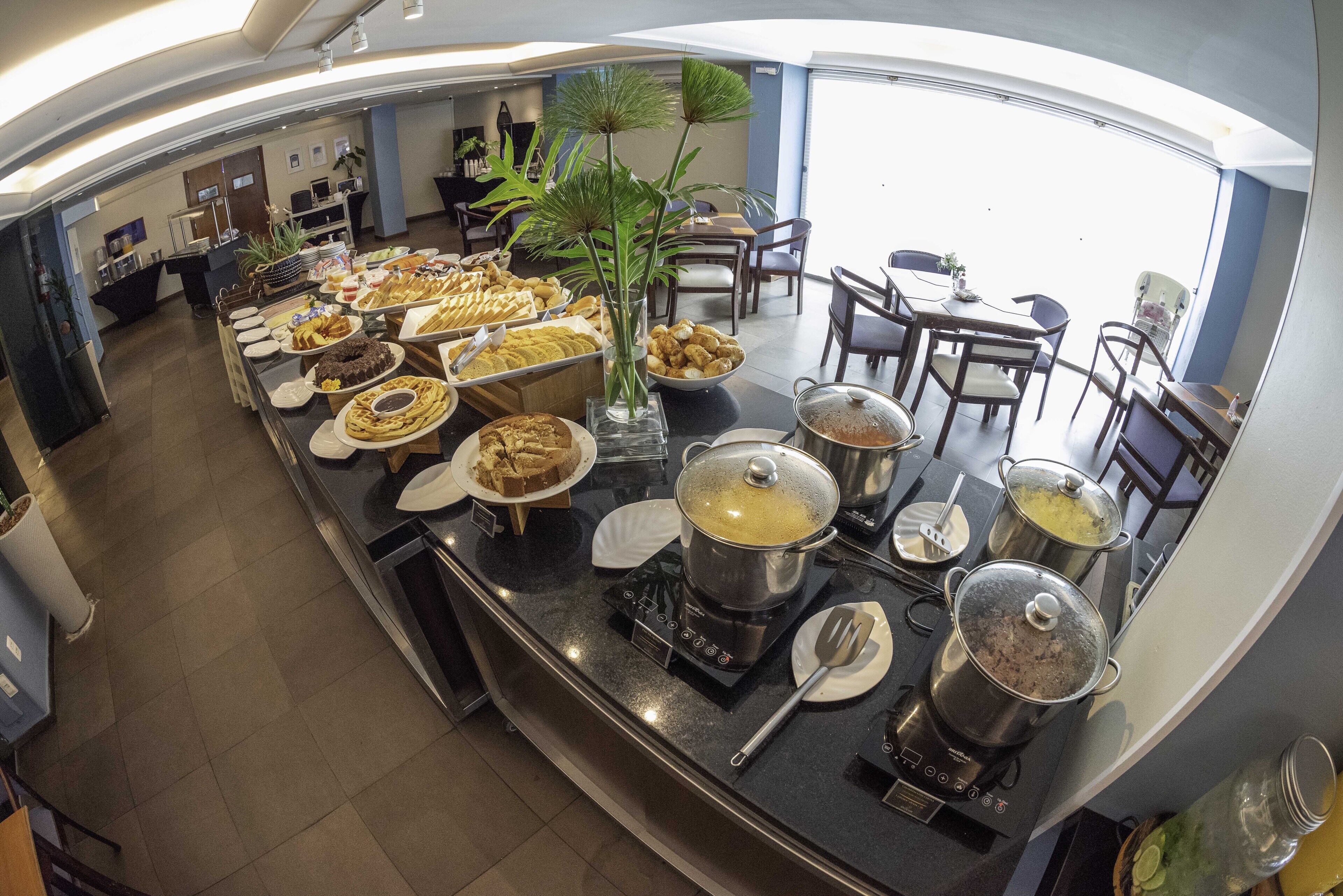A buffet area with various food items and a self-service hot pot station.