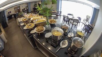 A buffet area with various food items and a self-service hot pot station.