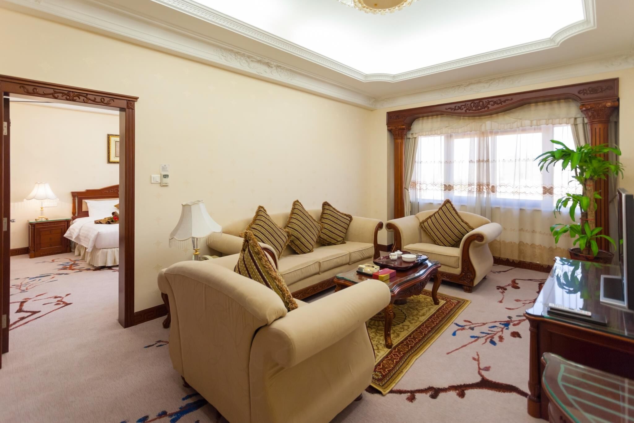 A well-furnished living room with a sofa set, a coffee table, and a television.