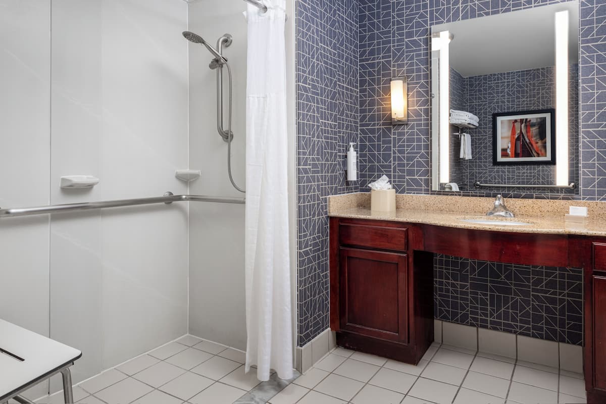 Deep soaking tub, hydromassage showerhead, designer toiletries