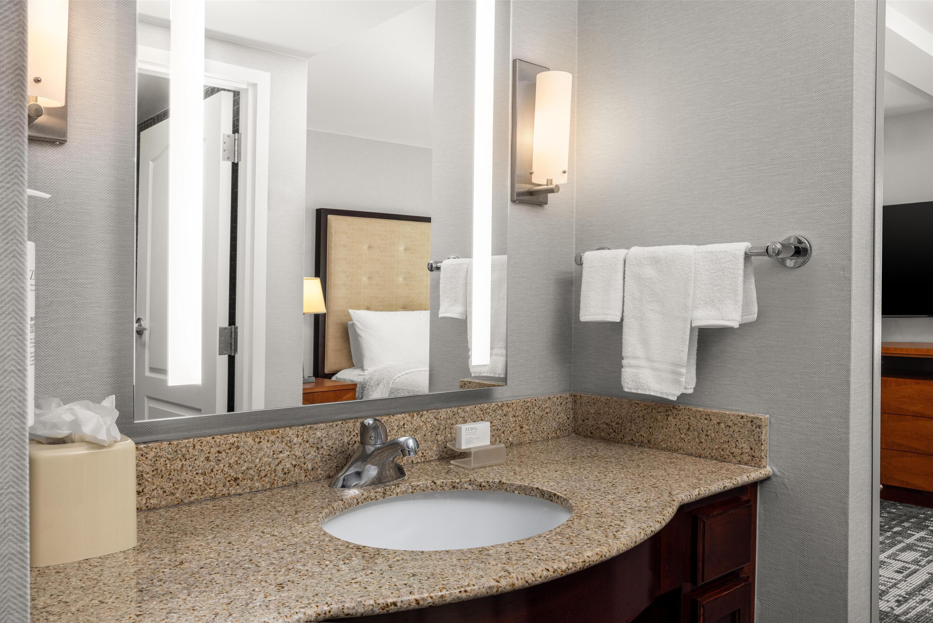 deep-soaking bathtub, hydromassage showerhead, designer toiletries