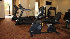 A gym with treadmills, an elliptical, and a stationary bike.