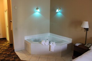 Suite, 1 trĂšs grand lit, baignoire Ă jets (Additional Living Area) | Coffres-forts dans les chambres, bureau, fer et planche Ă repasser