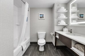 A modern bathroom with a toilet, shower, and vanity. - Hampton Inn Salem, VA (Salem)