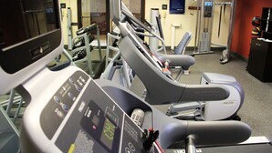 A gym with treadmills, weight machines, and a water fountain.