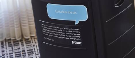 A black air purifier with a control panel and a message saying "Let's clear the air."