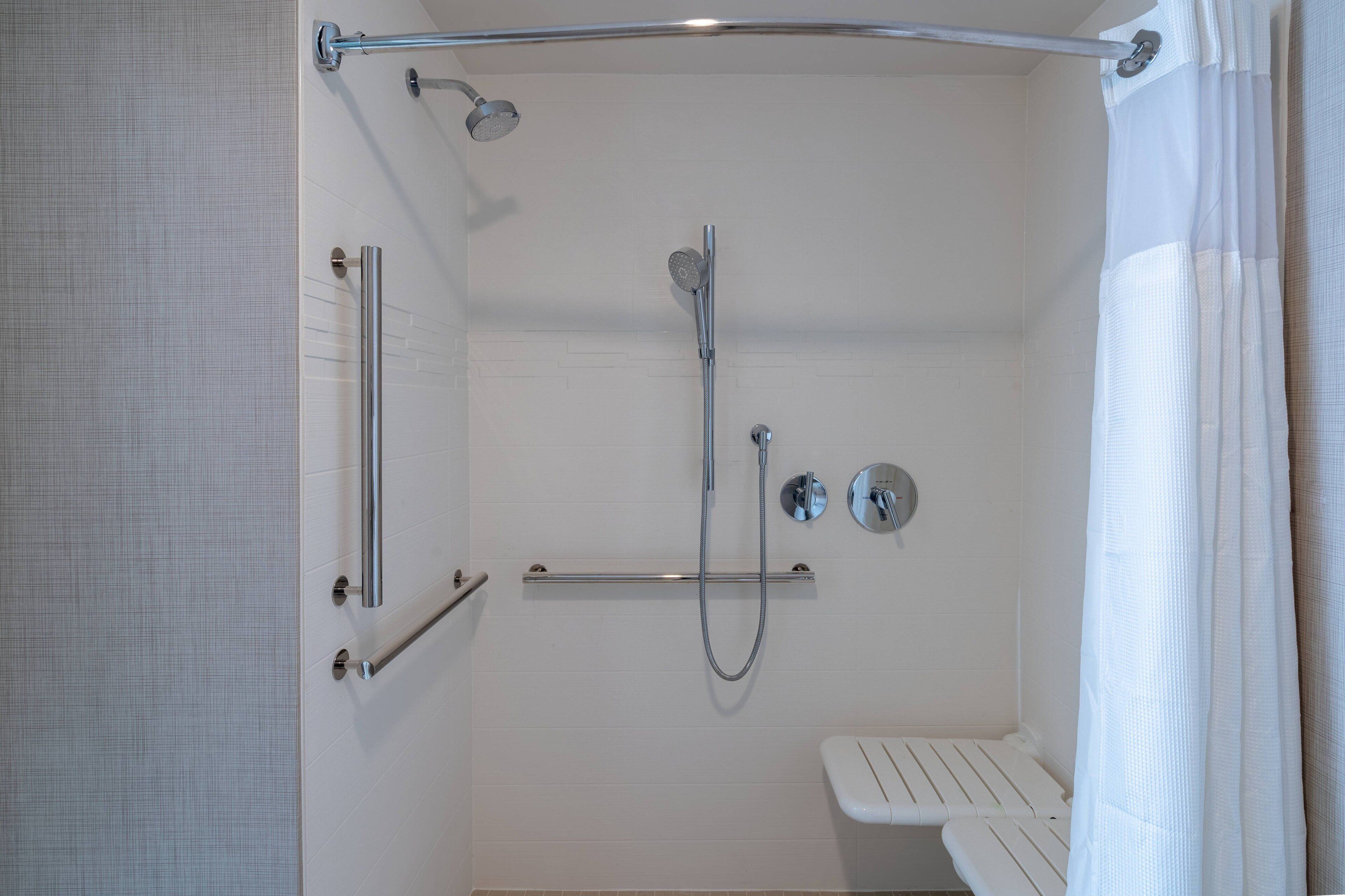 combined shower/bathtub, designer toiletries, hair dryer, towels