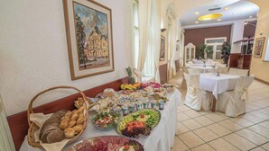 A buffet table with various food items and a painting on the wall. - Teledom Hotel & Conference Center (Kosice)