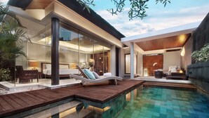 A modern house with a swimming pool, wooden deck, and glass walls. - Bali Mandira Beach Resort & Spa (Legian)