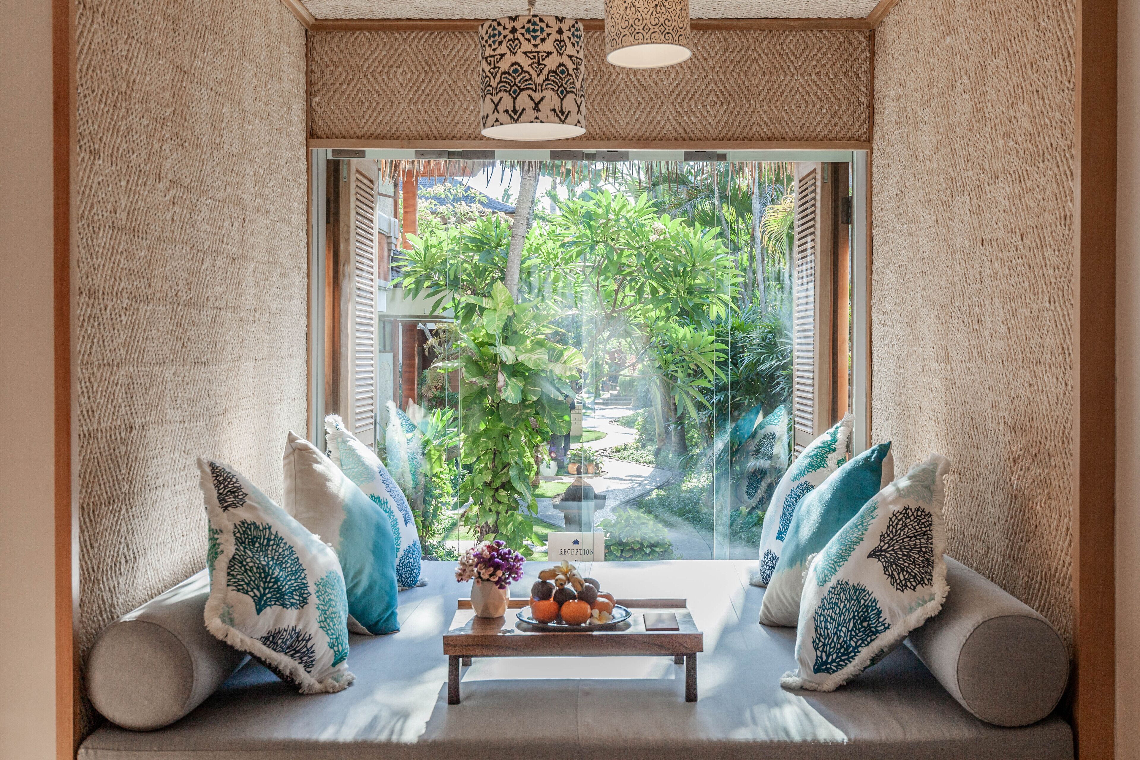 A cozy seating area with a view of lush greenery outside.