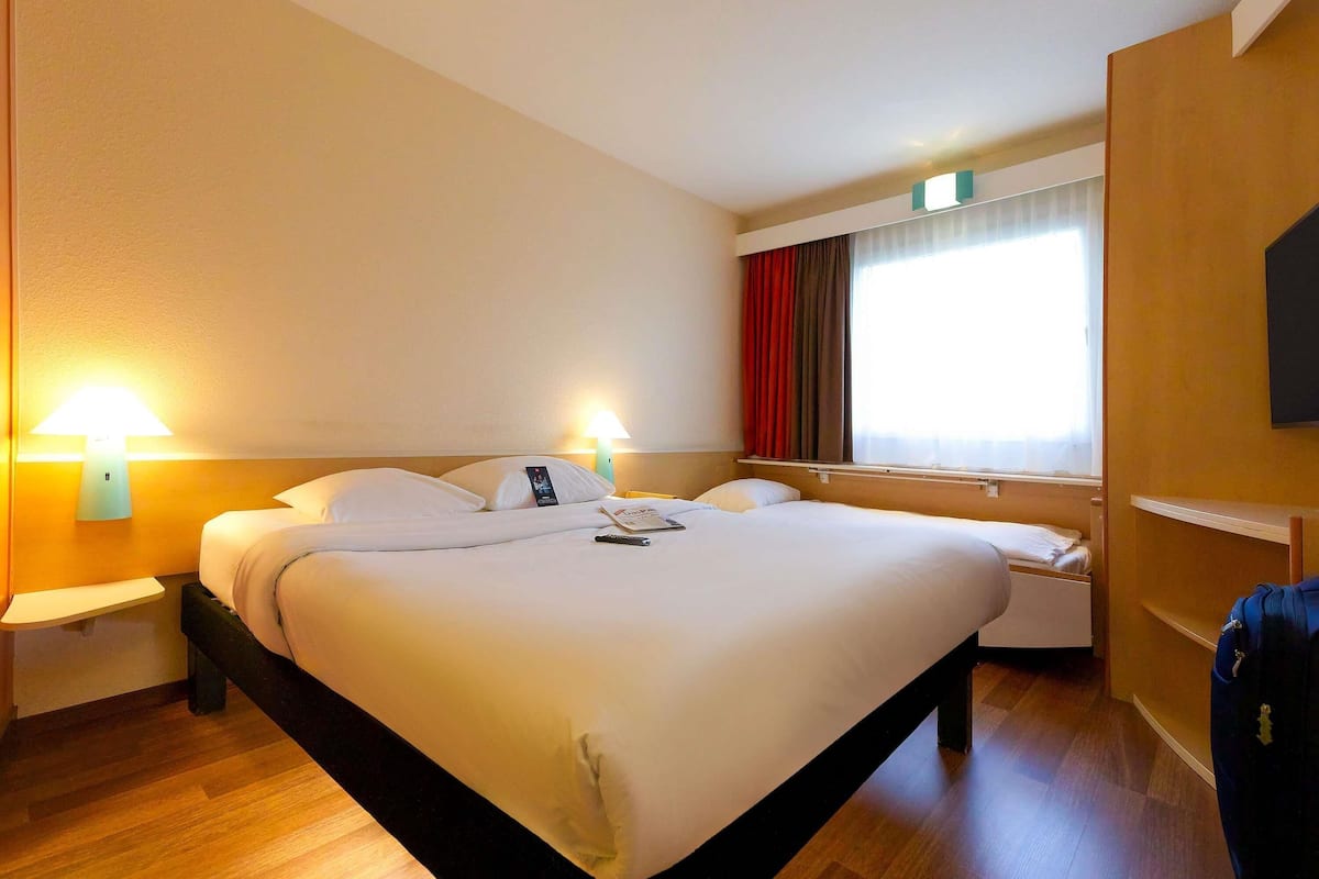Hypo-allergenic bedding, desk, laptop workspace, blackout drapes