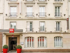 A hotel facade with a sign for 'ibis Hotels Paris Tour Montparnasse' and numbered windows. - Ibis Paris Tour Montparnasse 15eme (Paris)