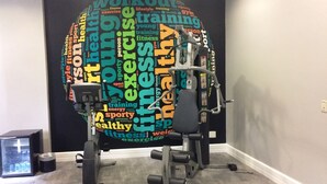 A home gym with a wall-mounted exercise machine and free weights. - Mercure São Paulo Paulista Hotel (São Paulo)