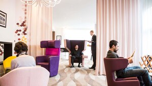 A modern hotel lobby with plush seating, a chandelier, and a large window with curtains. - Mercure São Paulo Paulista Hotel (São Paulo)