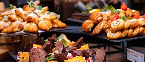 A variety of pastries and desserts displayed on a counter.