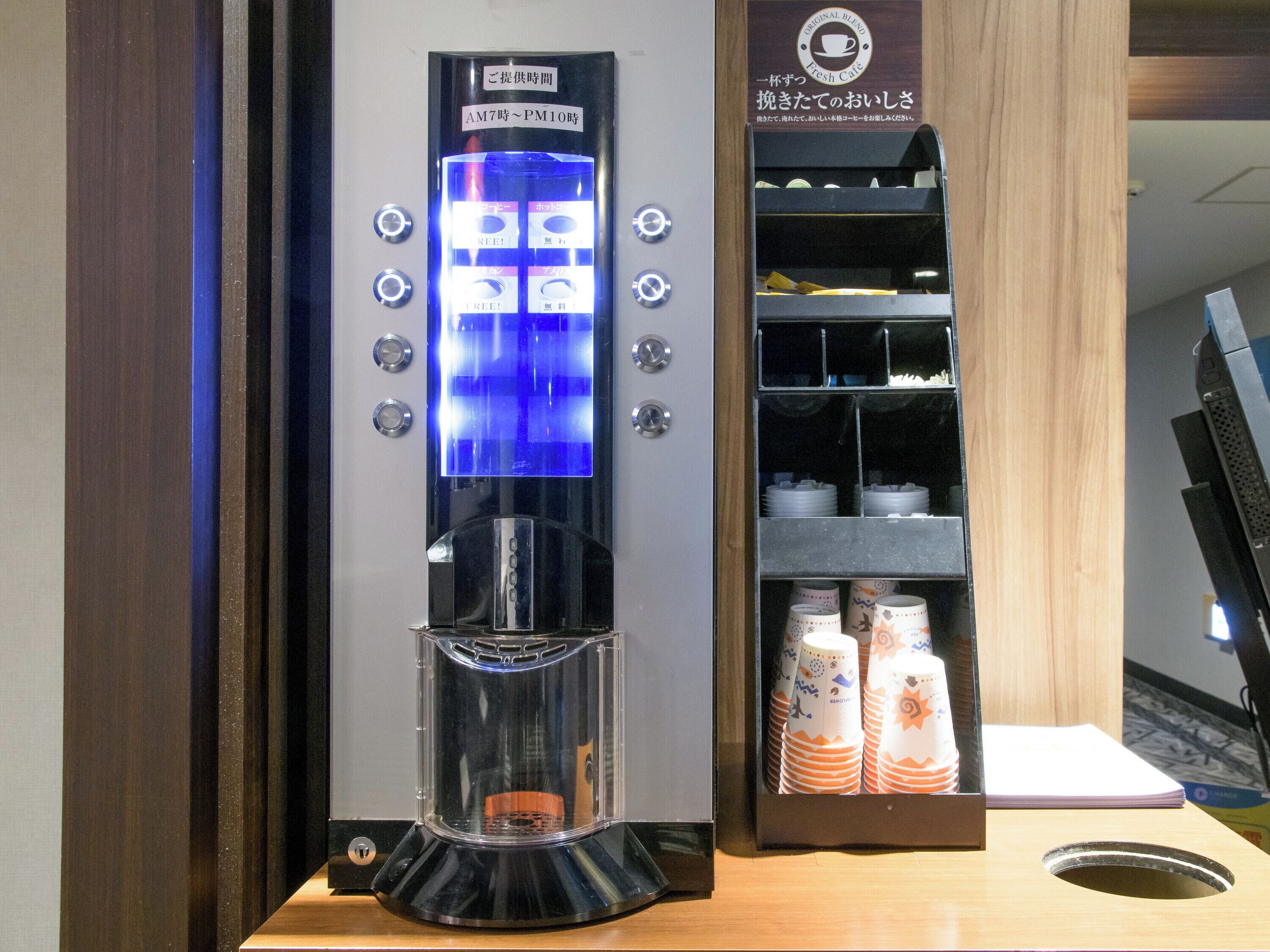 A coffee machine with a digital display and a coffee cup holder.