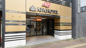 The exterior of Tkp Sapporoekimae, a hotel with a modern facade, large glass entrance, and a prominent Tkp logo. - APA Hotel TKP Sapporo Ekimae (Sapporo)