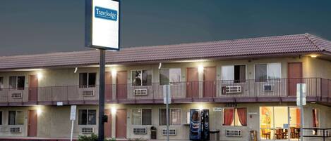 A Travelodge motel with a two-story structure, balconies, and a visible office entrance.