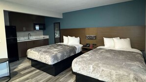 A hotel room with two beds, a kitchenette, and a bathroom. - Baymont by Wyndham Coalinga (Coalinga)
