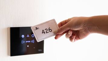 A hand inserting a key card into a keypad with the number 426.