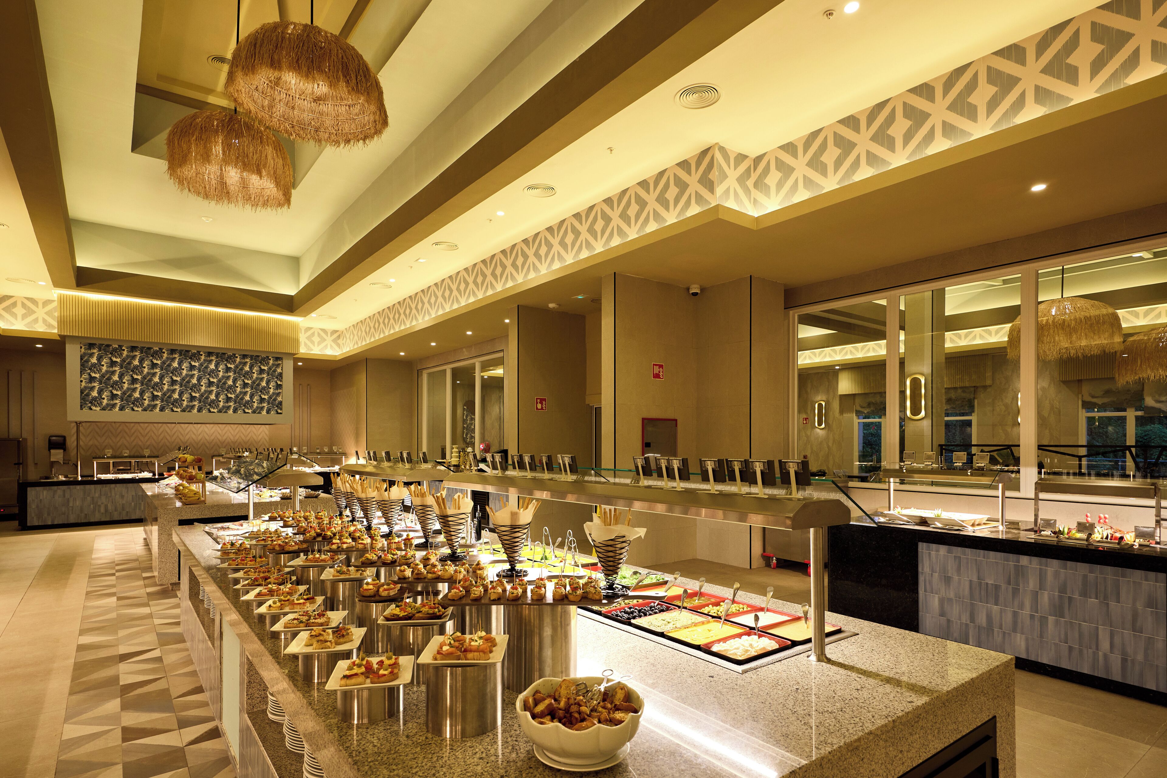 A buffet area with various food stations and a long counter.